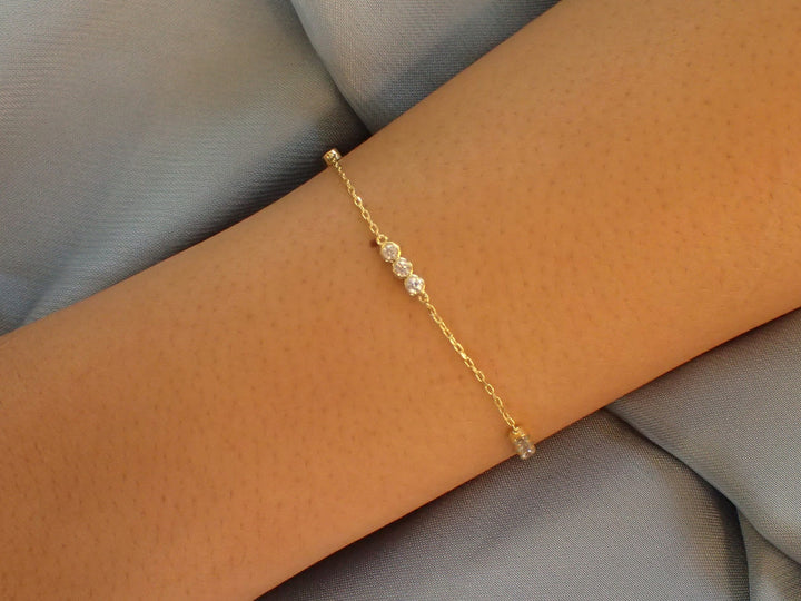 Three-Stone CZ Bezel Bracelet in Sterling Silver — on-hand view