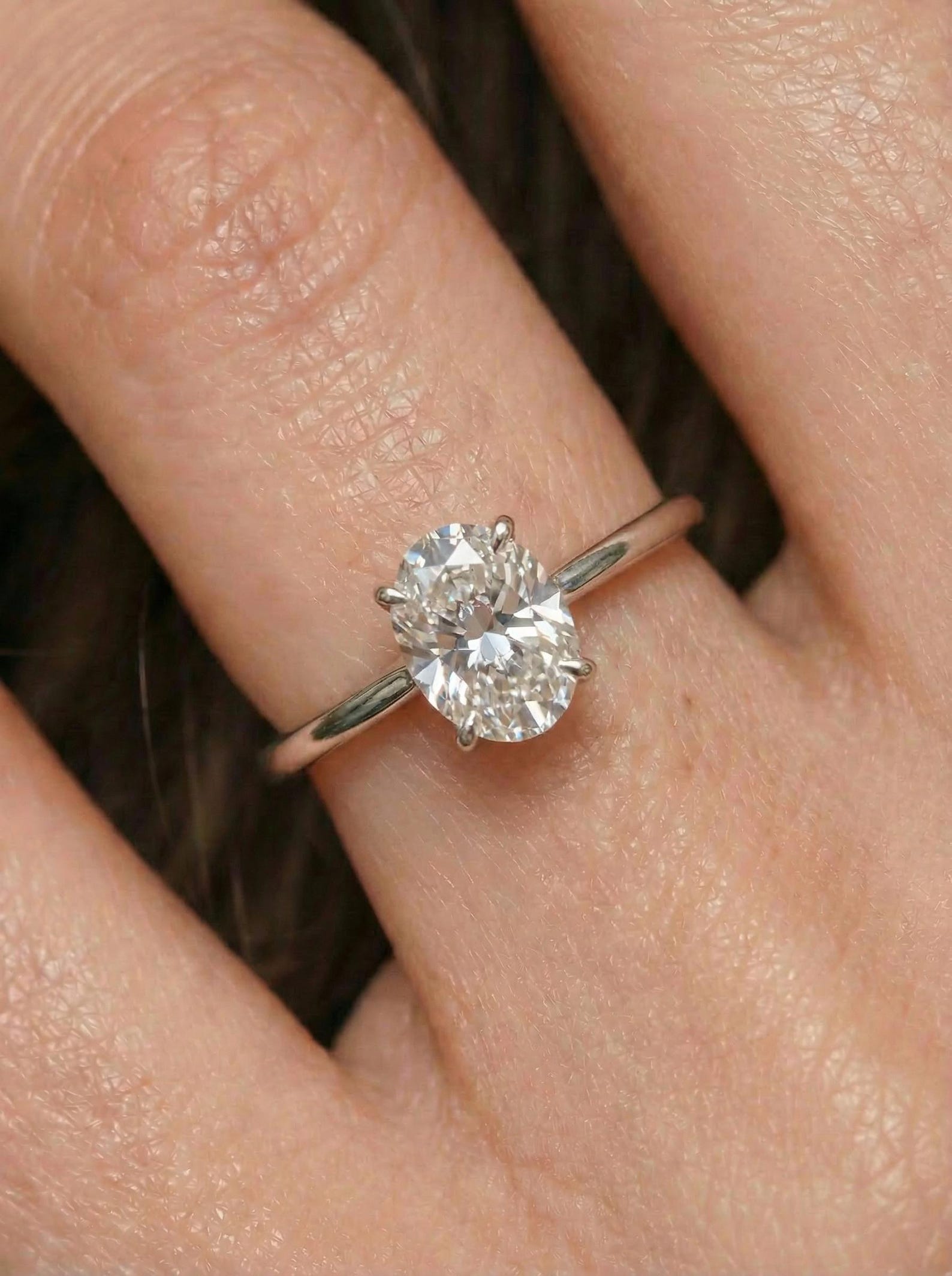 Oval Moissanite Engagement Ring in Sterling Silver — on-hand view