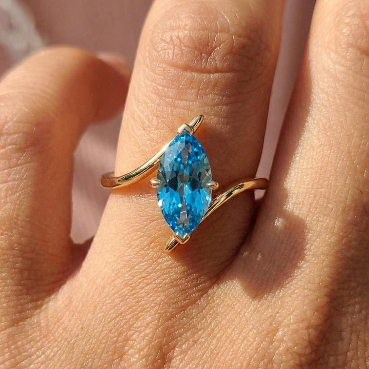 1.5ct Marquise Blue Zircon Ring, December Birthstone Engagement Ring, 14K Gold Curved Bypass Nature Inspired Ring